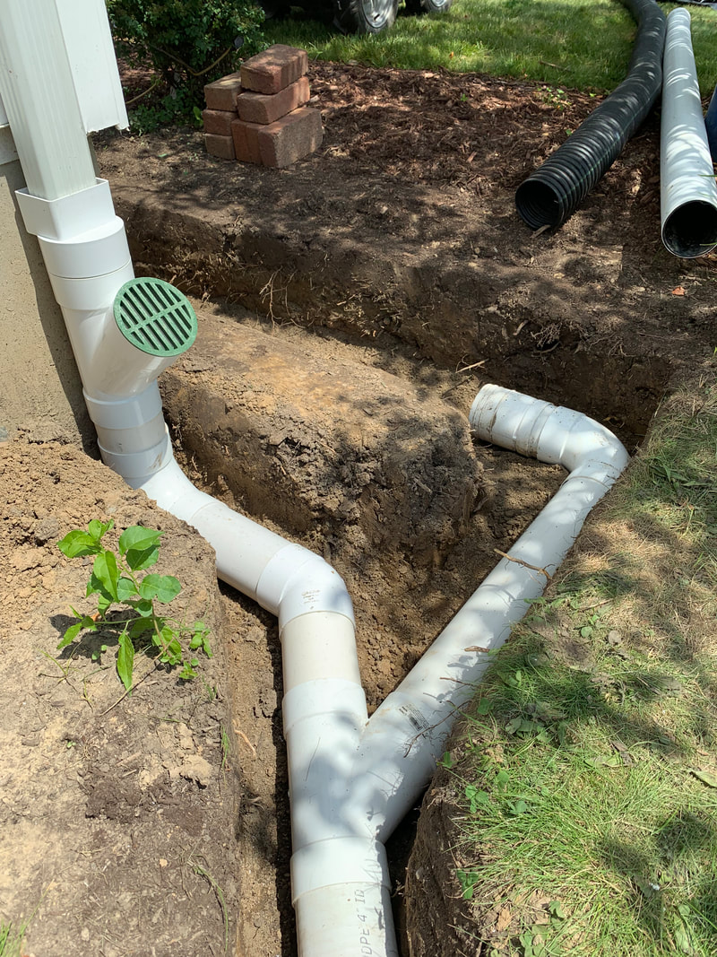 DIY drainage solutions for the outside of a home, landscape, and yard. How to install drainage ideas for a french drain, catch basin, dry well, underground downspout pipe, sump pump discharge, gutter water, and exterior foundation drains.