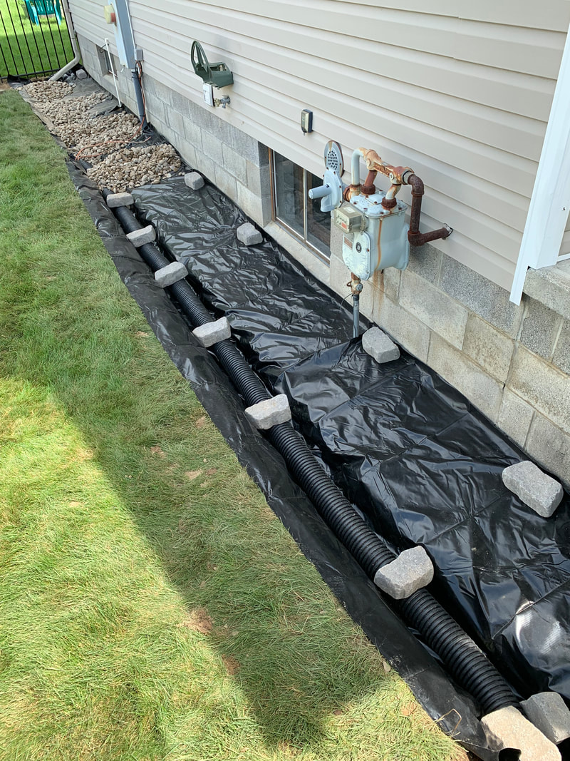 How to install drainage outside a house pictures. DIY drainage system ideas for a french drain, dry well, underground downspout, sump pump discharge, catch basin, gutter water, landscape beds, foundation repair, and standing water issues in a yard.