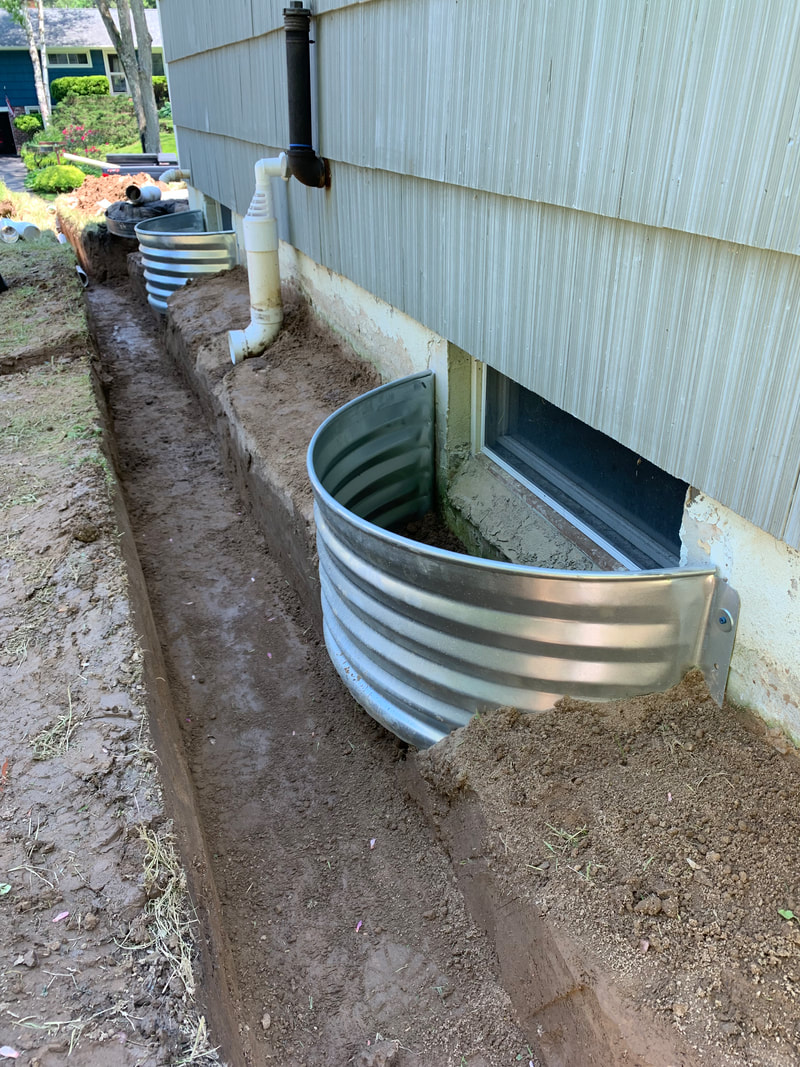 DIY drainage ideas for the exterior of a house, landscape, and yard. How to install a french drain, dry well, underground downspout, sump pump discharge pipe, gutter water, foundation drains, catch basins, and more drainage solutions.